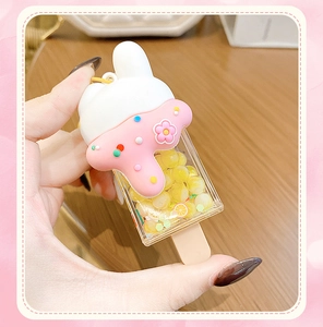 Detailed shot of creative rabbit ice cream keychain with pink liquid and glitter charms