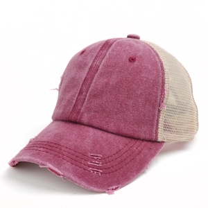 Close-up of distressed edges and breathable mesh on vintage burgundy trucker hat