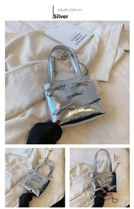 Detail view of silver glossy mini tote bag with five bow accents and metal ball chain