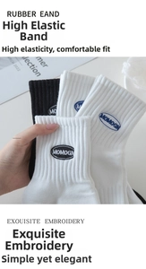 Detail of high-elastic ribbed cuffs and letter embroidery on white and black cotton socks