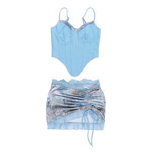 Flat lay of light blue lace corset top and marble print drawstring mini skirt set
