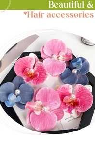 Close-up of silk orchid hair clips with center pearl detail in multi-color set