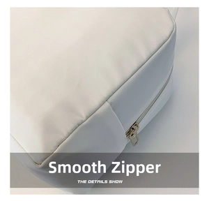 Close-up of smooth metal zipper and stitching detail on the white insulated bag