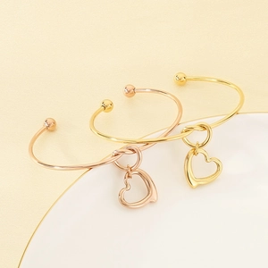 Minimalist 18K gold plated stainless steel open bangle with hollow heart charm