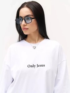 Close-up of Only Jesus text print on white cotton tee with a heart necklace
