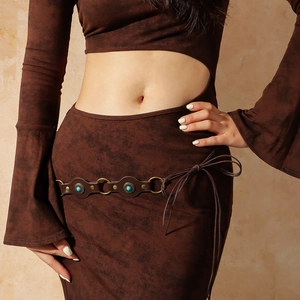 Detail of vintage brown leather belt with turquoise stone inlays and metallic rings