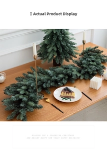 Close-up of dense green Christmas garland with pine needles on a rustic wooden table