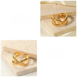 Detail view of gold-plated stainless steel criss-cross ring with polished finish