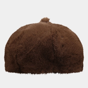 Detailed view of dark brown plush faux fur fabric texture on a warm beret hat