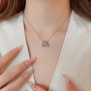 Elegant pumpkin carriage necklace with pink heart crystal on a model, silver finish