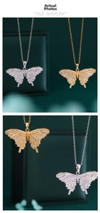 Macro shot of 18K gold and silver butterfly pendants with shimmering zircon pavé stones