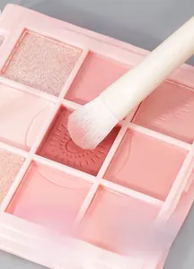 Macro shot of fine soft brush bristles picking up pink shimmer eyeshadow powder