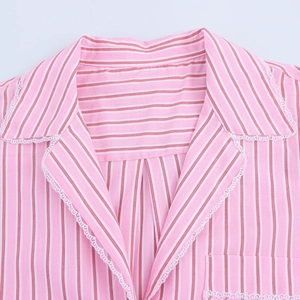 Detail shot of a pink striped shirt featuring delicate white lace trim on the collar