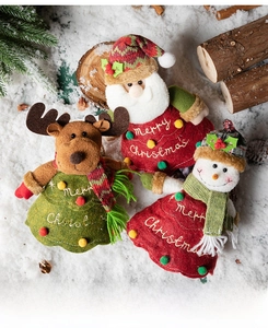 Three Christmas felt plush figurines featuring Santa, reindeer, and snowman in snowy setting