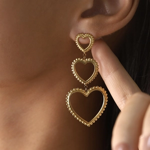 Three-layered golden heart drop earrings with bead texture for a retro French style