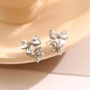 Sweet silver bow earrings with heart-shaped zircon, star pendant and sparkly accents