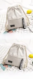 Detail of off-white canvas drawstring backpack with cotton straps and fashion label
