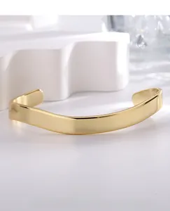 Macro detail of gold plated irregular wavy cuff bracelet with high polish finish