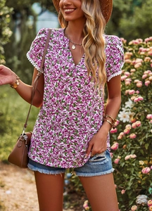 Detail of elegant V-neck floral blouse featuring puff sleeves with white lace trimmings