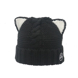 Winter knitted beanie with cat ears and cable knit texture in black and white