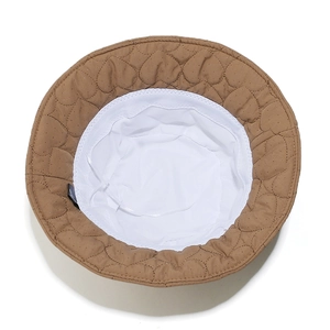 Detail of heart-quilted brown bucket hat with adjustable inner drawstring and white lining