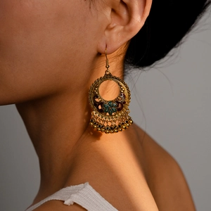 Vintage bohemian gold flower drop earrings with teal enamel and metallic beads on model