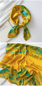 Detail of satin silk scarf featuring traditional Chinese landscape art in yellow and blue
