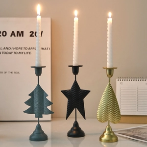 Nordic metal candle holders in star, heart, and tree shapes for festive table decor