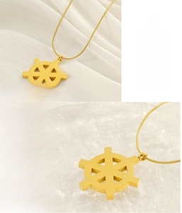 Macro detail of 18K gold stainless steel rudder pendant with lead-free snake chain