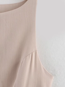 Close-up of beige twill fabric texture and neat shoulder stitching for a commuter dress