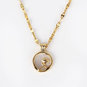 Macro detail of a golden vintage necklace featuring a 3D rose on a white shell pendant