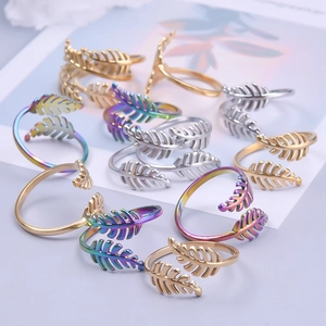 Detailed view of adjustable leaf rings in gold, silver and rainbow stainless steel finishes