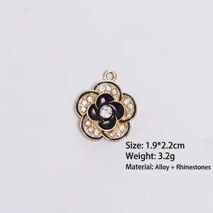 Detail of camellia flower charm with black enamel and rhinestones 1.9x2.2cm