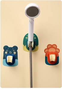 Adjustable cartoon shower head holder with bear and dinosaur designs, no-drill adhesive