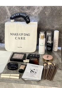 Detail of cream travel makeup bag with pearl handle and hanging hook for toiletries