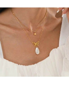 Detail of 14K gold double-layer necklace with butterfly pendant and white drop pearl