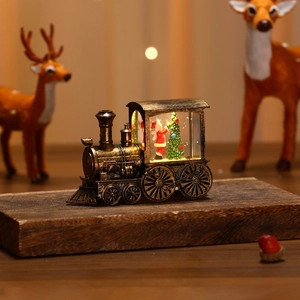 Vintage bronze steam train Christmas lantern with warm LED Santa Claus landscape