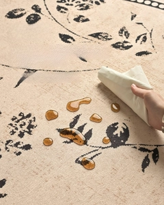 Waterproof round rug detail showing liquid beads on French vintage floral surface