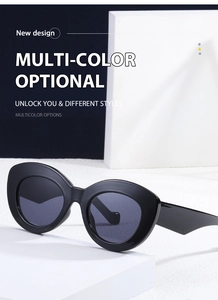Detailed view of black cat-eye sunglasses on geometric props with blue and white background