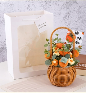 Detailed shot of handmade crochet persimmon flower basket inside a white gift bag