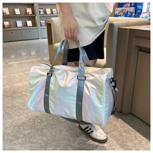 Holographic gradient travel bag detail with grey webbing handle and metallic finish