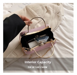 Interior view of purple sequin clutch bag showing gold chain strap and pearl clasp detail