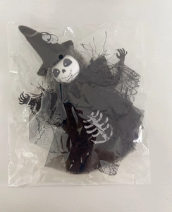 Detail view of Halloween witch skeleton ghost decoration in plastic packaging