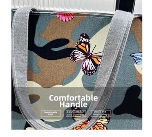Detail of gray woven handles and butterfly camouflage print on canvas tote bag