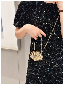 Chic gold shell-shaped zinc alloy evening bag with beaded chain strap shown on model
