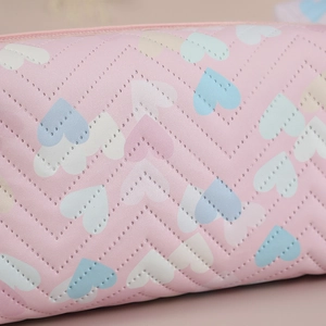 Pink PU makeup bag with gradient heart patterns and V-shaped stitching detail