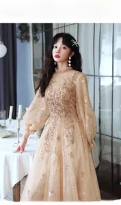 Detail of champagne lace dress featuring vintage high neck and gold sequin embroidery