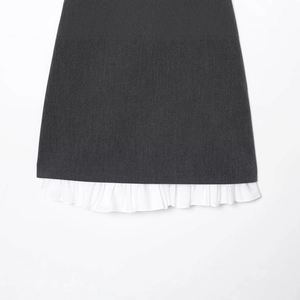 Fashionable dark grey mini dress featuring a white pleated ruffled hem on a clean white background