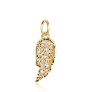 Detailed macro view of a golden wing pendant inlaid with sparkling white zircons