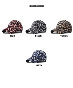 Floral patterned baseball caps in red, black, yellow, and navy with abstract flower motifs